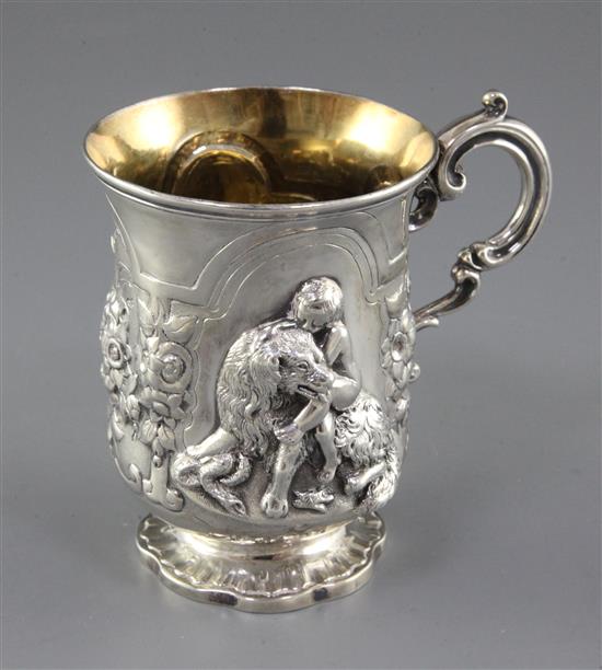 A Victorian silver christening mug embossed with a child and seated dog, 7 oz.